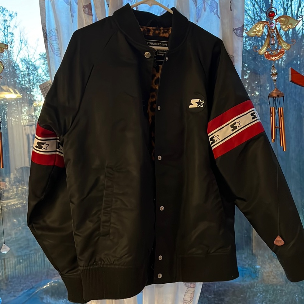 This is a woman’s Starter jacket with leopard on the inside. The size is Large.